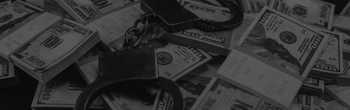 pile of money with handcuffs sitting on top pile of money with handcuffs sitting on top